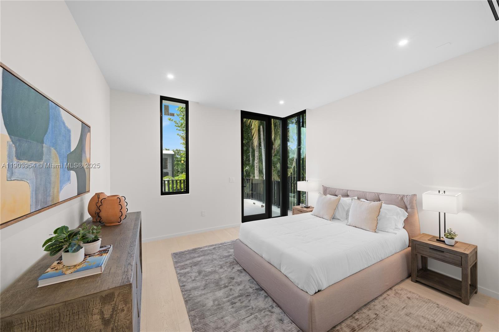 2053 North Bay Road Miami Beach, FL 33140 - Photo 84 of 99 a bedroom with a large bed and a potted plant