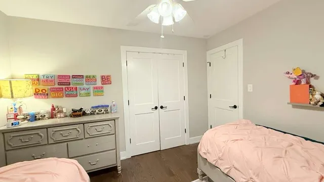 a bedroom with a bed and a dresser in it