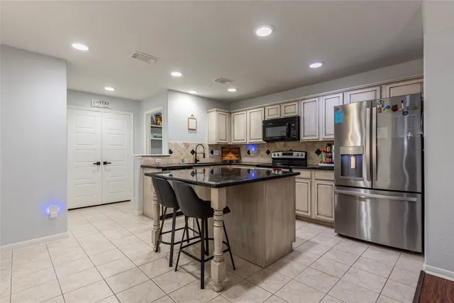 a kitchen with stainless steel appliances granite countertop a sink and cabinets