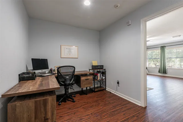 a spacious bedroom with a bed and a flat screen tv