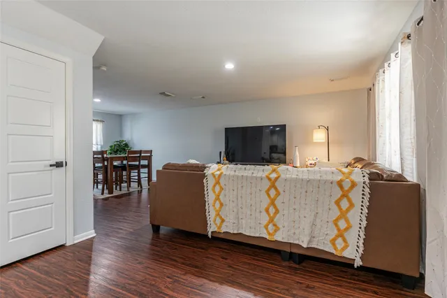 a living room with furniture and wooden floor