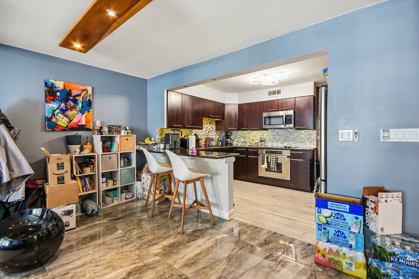 6007 North Sheridan Road, Unit 29F Chicago, IL 60660 - Photo 5 of 19 a open kitchen with stainless steel appliances granite countertop a stove top oven a dining table and chairs with wooden floor
