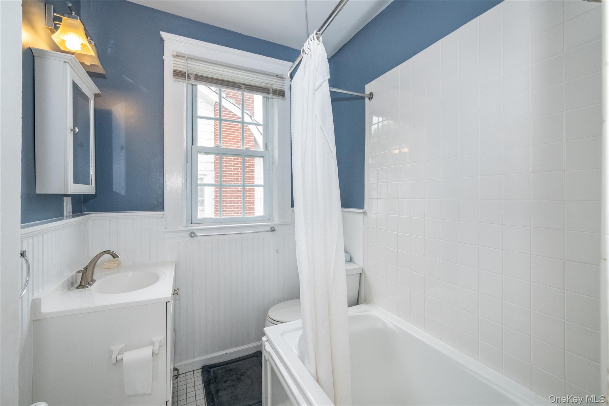 82 Clove Road New Rochelle, NY 10801 - Photo 22 of 39 a bathroom with a tub sink and mirror