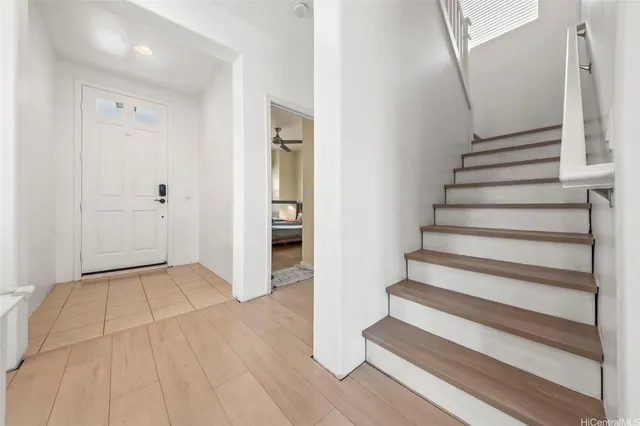 a view of an entryway with wooden floor and stairs