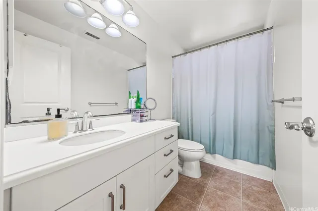 a bathroom with a double vanity sink mirror and toilet