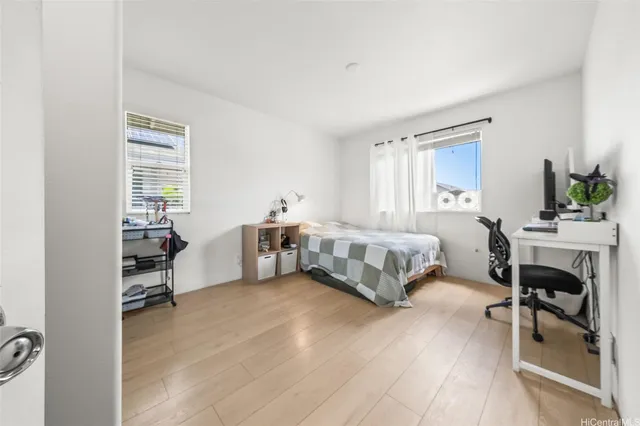 a bedroom with a bed and a table chair