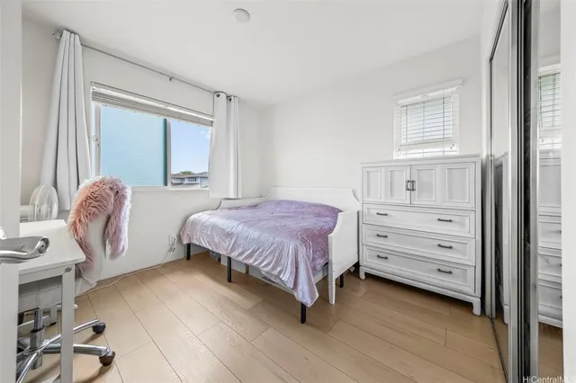 a spacious bedroom with a bed and a window