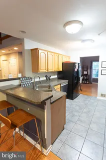 a kitchen with granite countertop a sink and cabinets