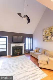 a living room with a couch fireplace and a fireplace