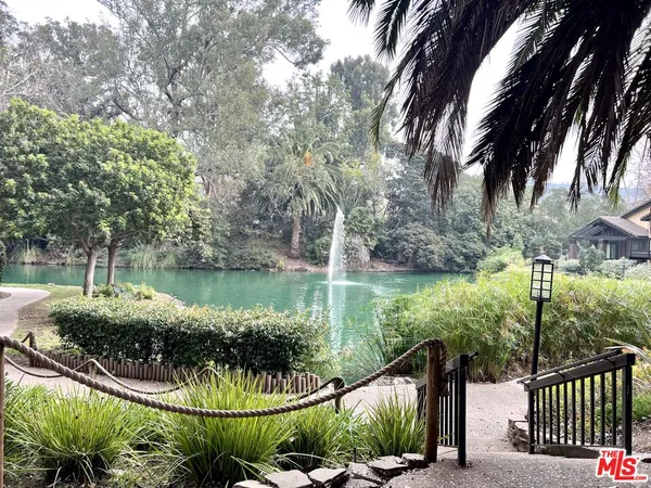 a view of a lake with a garden and deck