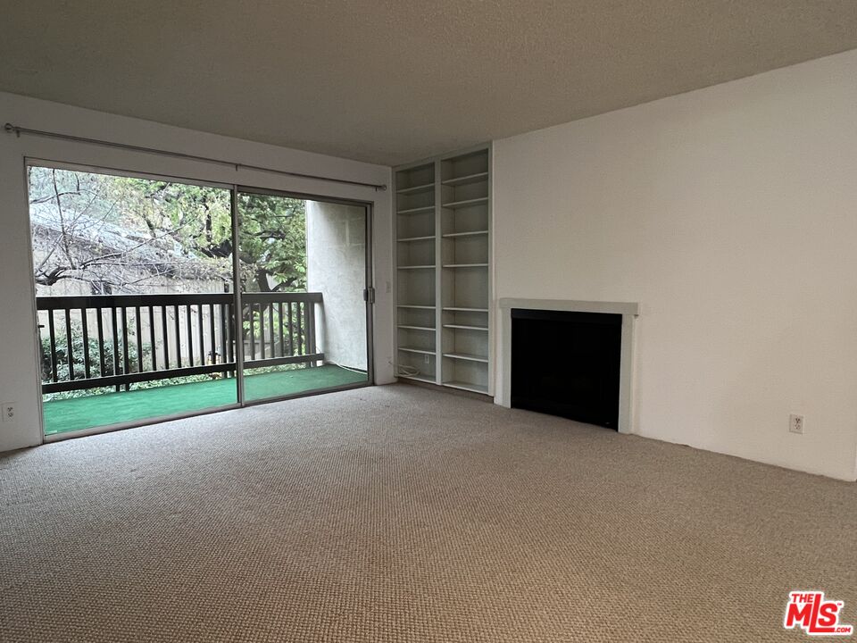 1115 Raintree Circle Culver City, CA 90230 - Photo 15 of 32 a view of an empty room with a fireplace and a window