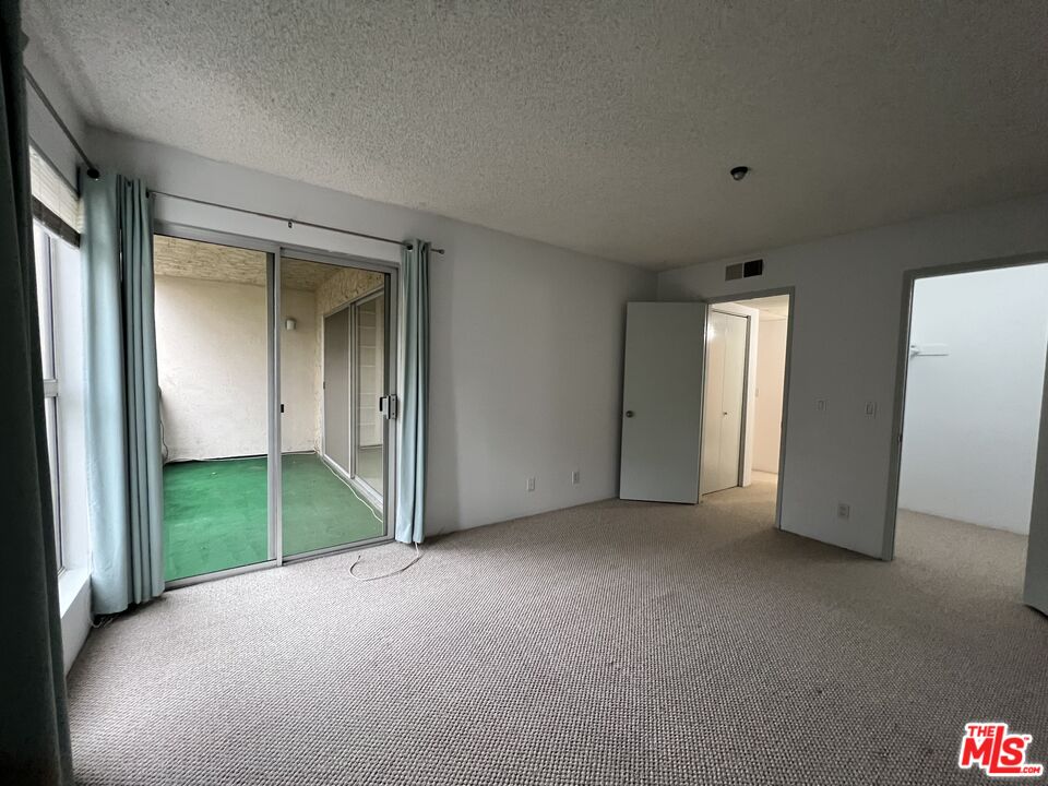 1115 Raintree Circle Culver City, CA 90230 - Photo 22 of 32 an empty room with windows and bathroom view