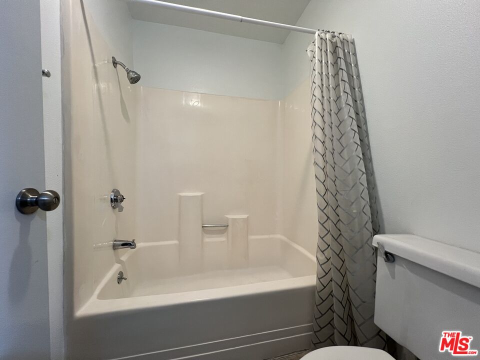 1115 Raintree Circle Culver City, CA 90230 - Photo 27 of 32 a bathroom with a bathtub and shower