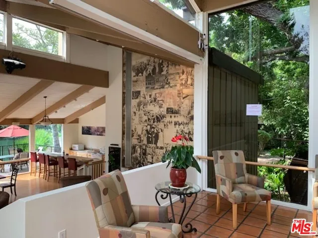 a view of a patio with table and chairs potted plants with wooden floor