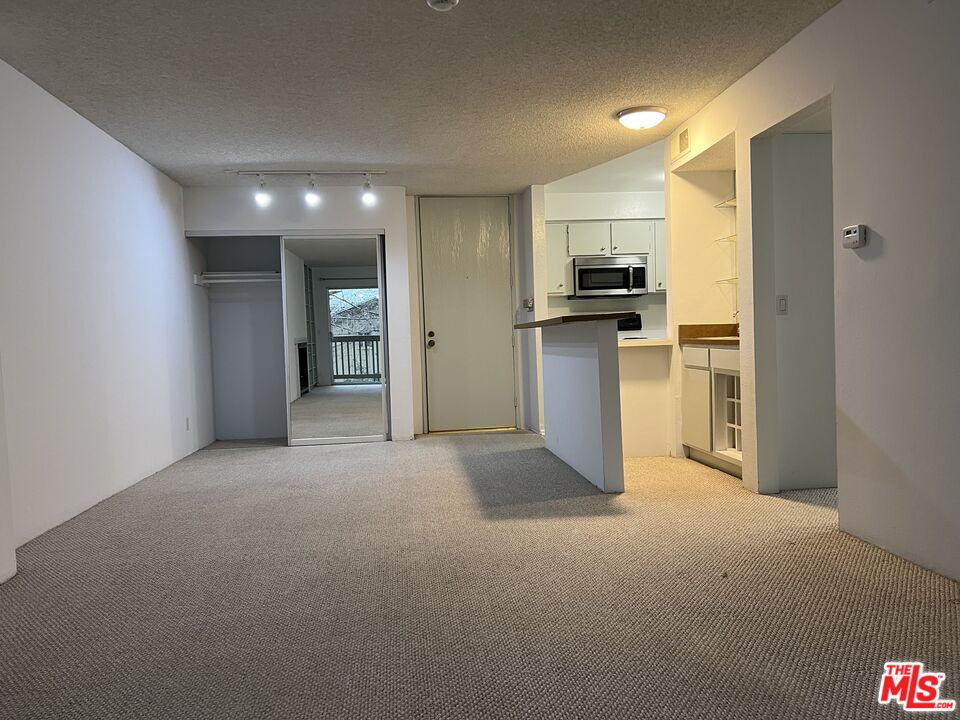 1115 Raintree Circle Culver City, CA 90230 - Photo 10 of 32 a view of a kitchen with a sink and a refrigerator