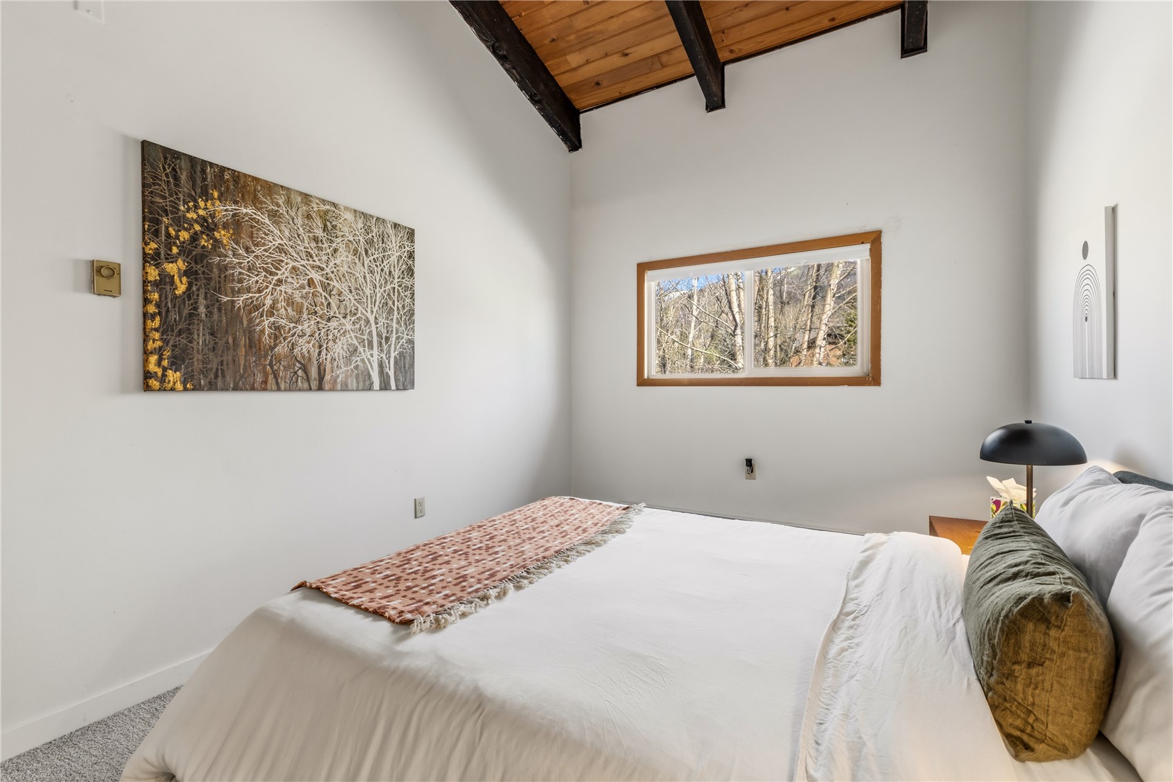 1375 Walton Creek Road, Unit 14 Steamboat Springs, CO 80487 - Photo 13 of 38 a bedroom with a bed and a painting on the wall