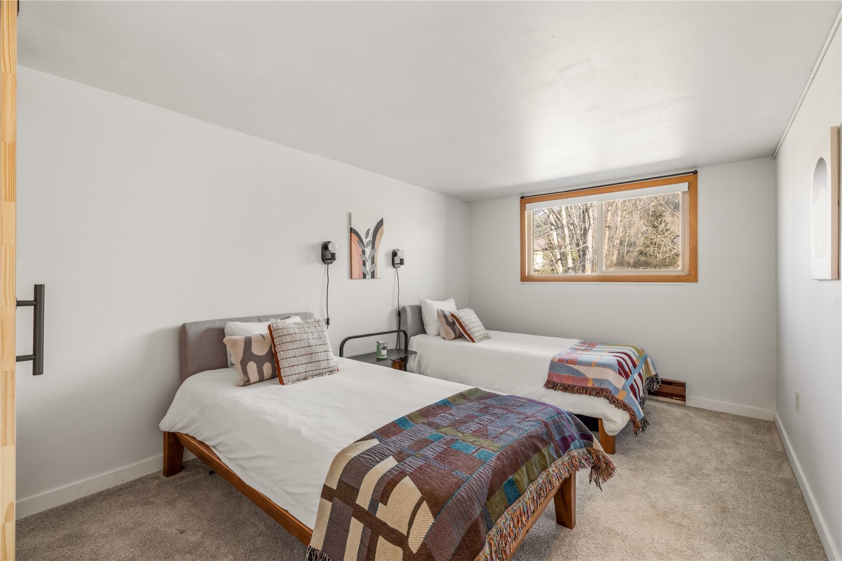 1375 Walton Creek Road, Unit 14 Steamboat Springs, CO 80487 - Photo 16 of 38 a bedroom with two beds and a painting on the wall