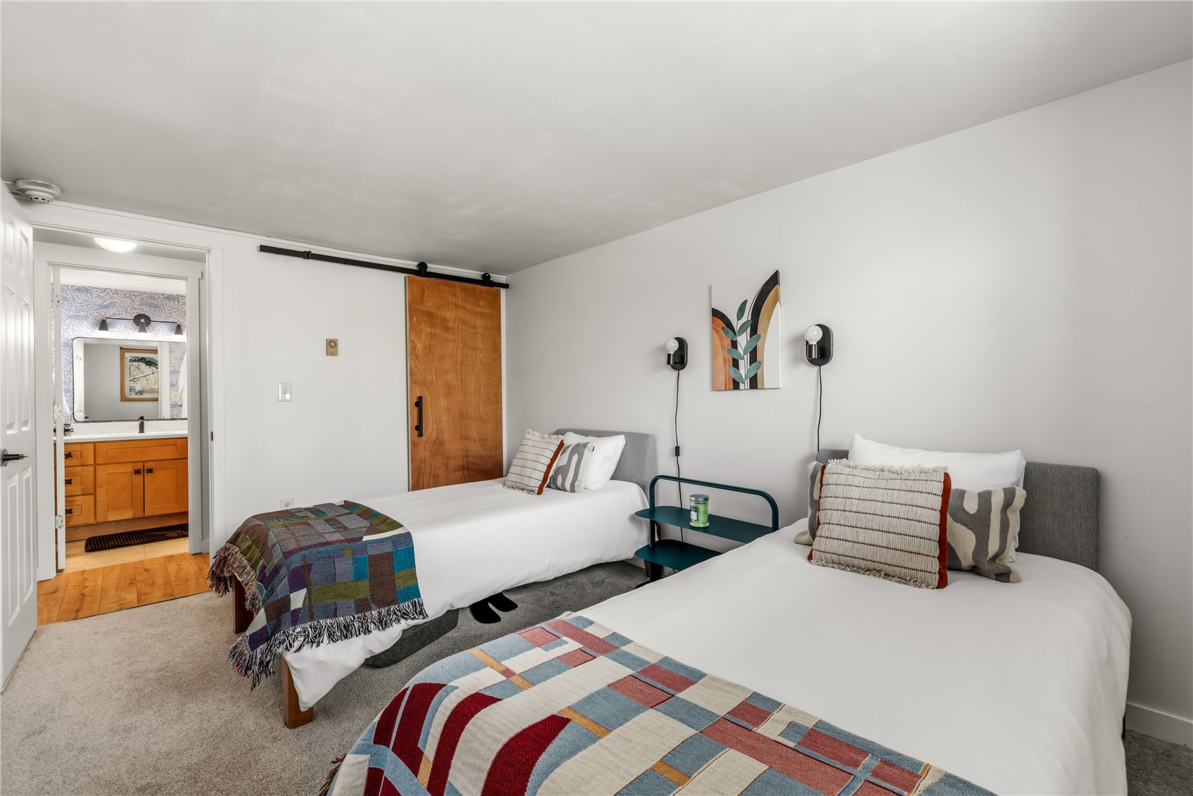 1375 Walton Creek Road, Unit 14 Steamboat Springs, CO 80487 - Photo 17 of 38 a bedroom with two beds and painted walls
