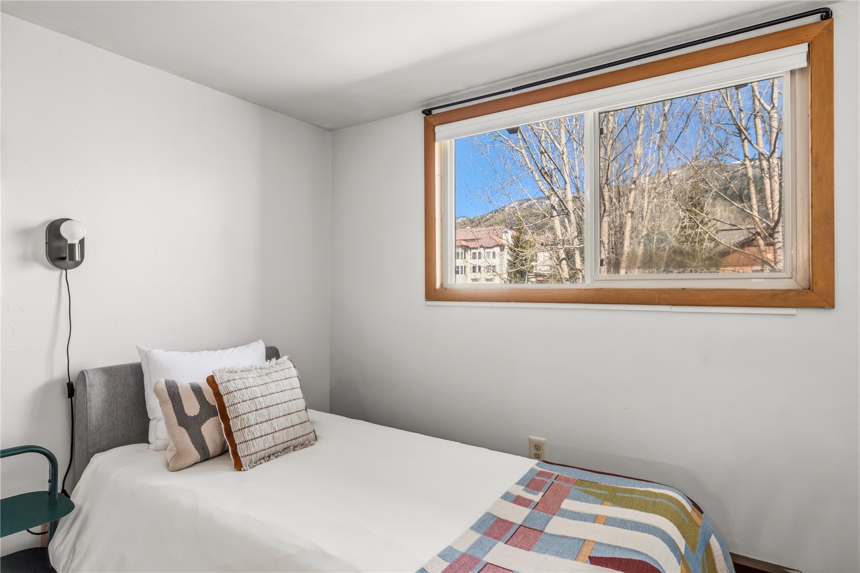 1375 Walton Creek Road, Unit 14 Steamboat Springs, CO 80487 - Photo 18 of 38 a bedroom with a bed and a painting on the wall