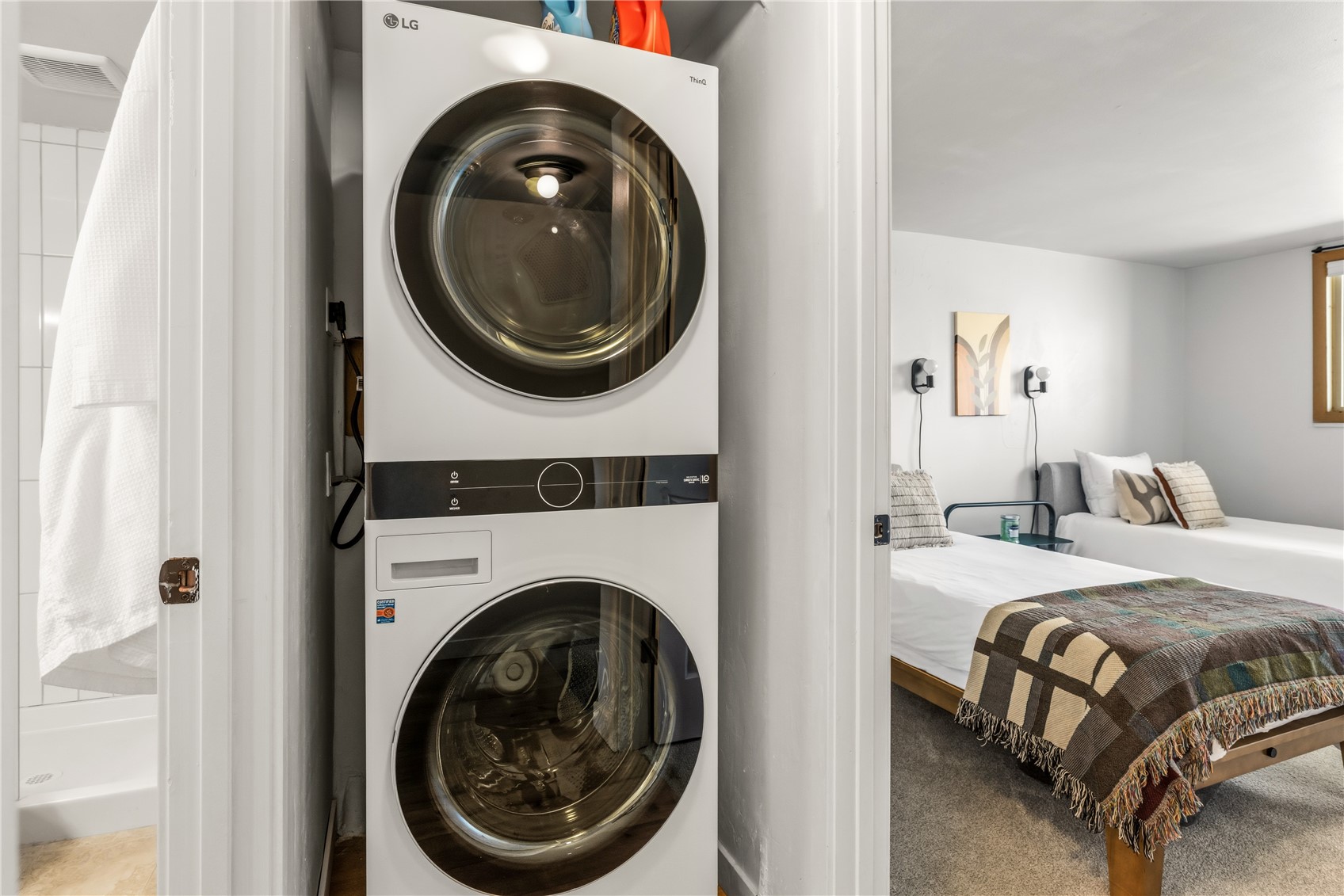 1375 Walton Creek Road, Unit 14 Steamboat Springs, CO 80487 - Photo 20 of 38 a bedroom with a washing machine and a washer dryer