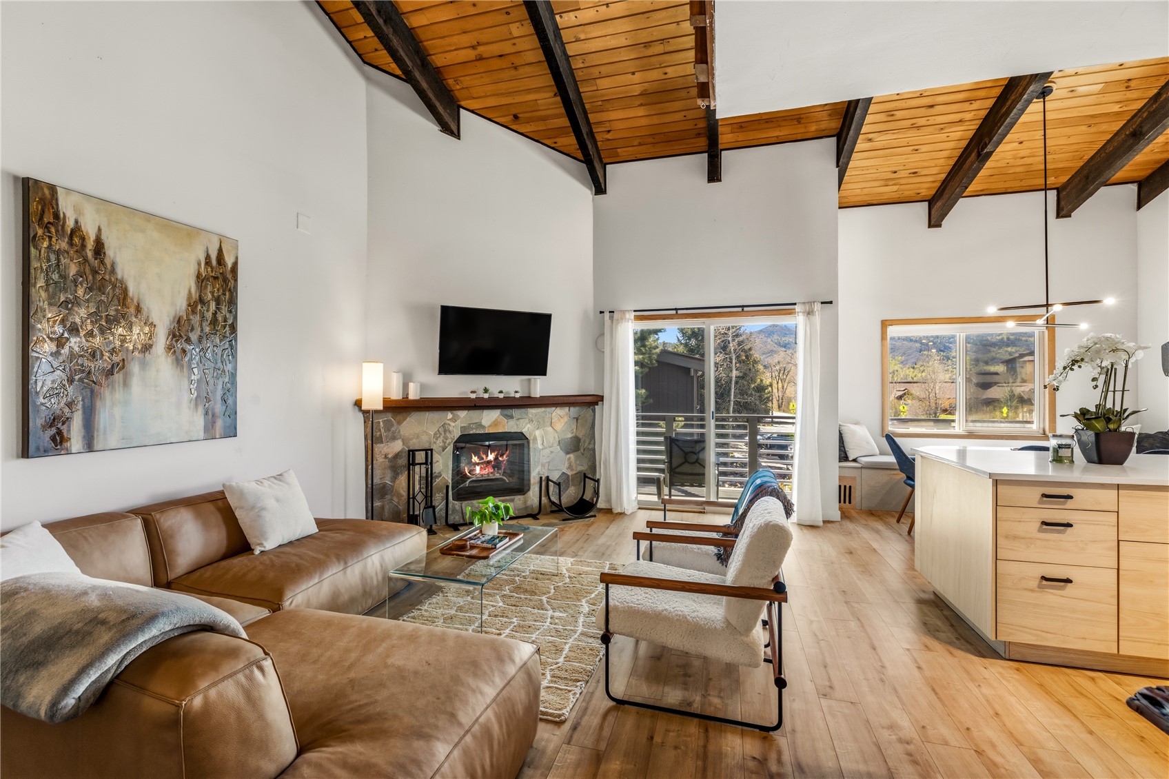 1375 Walton Creek Road, Unit 14 Steamboat Springs, CO 80487 - Photo 2 of 38 a living room with furniture a fireplace and a flat screen tv