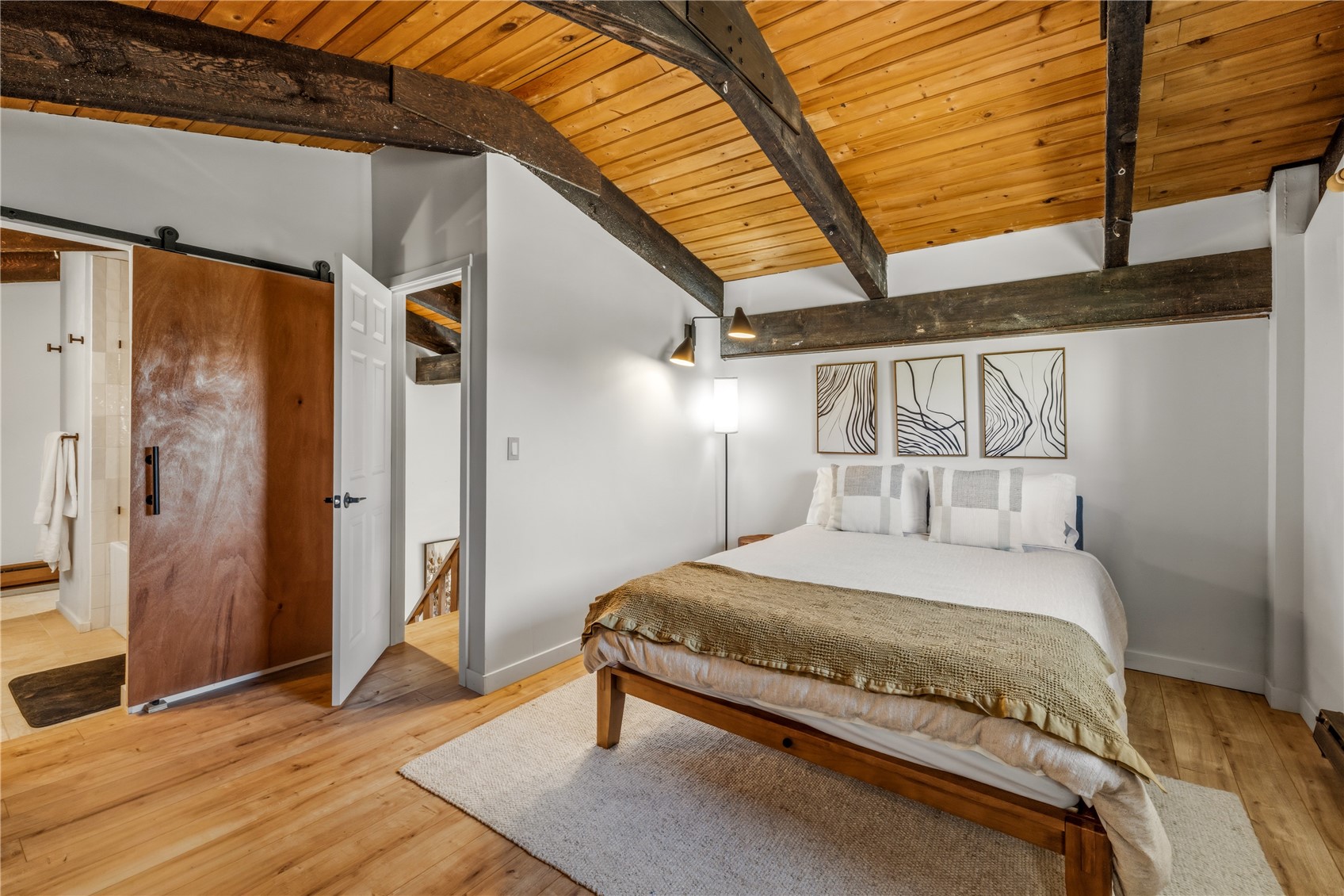 1375 Walton Creek Road, Unit 14 Steamboat Springs, CO 80487 - Photo 22 of 38 a bedroom with a bed and wooden floor