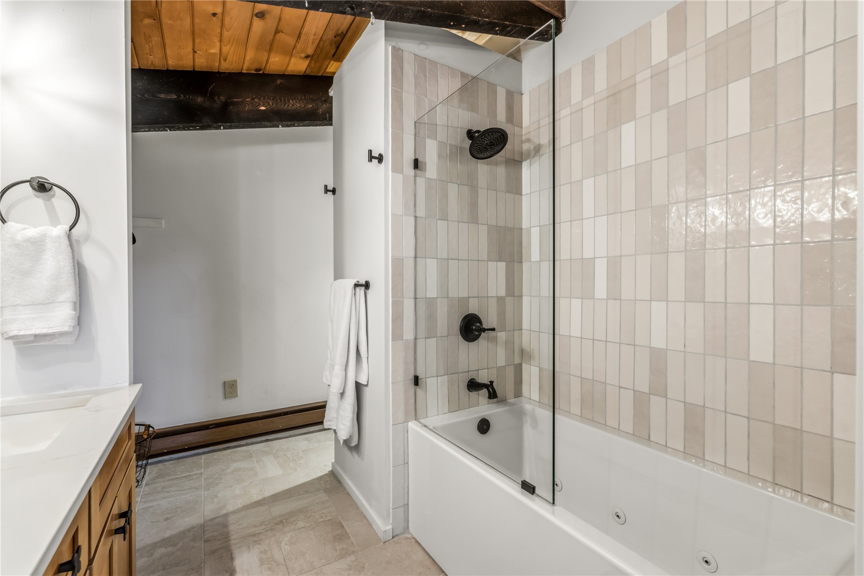 1375 Walton Creek Road, Unit 14 Steamboat Springs, CO 80487 - Photo 25 of 38 a bathroom with a bathtub and a shower
