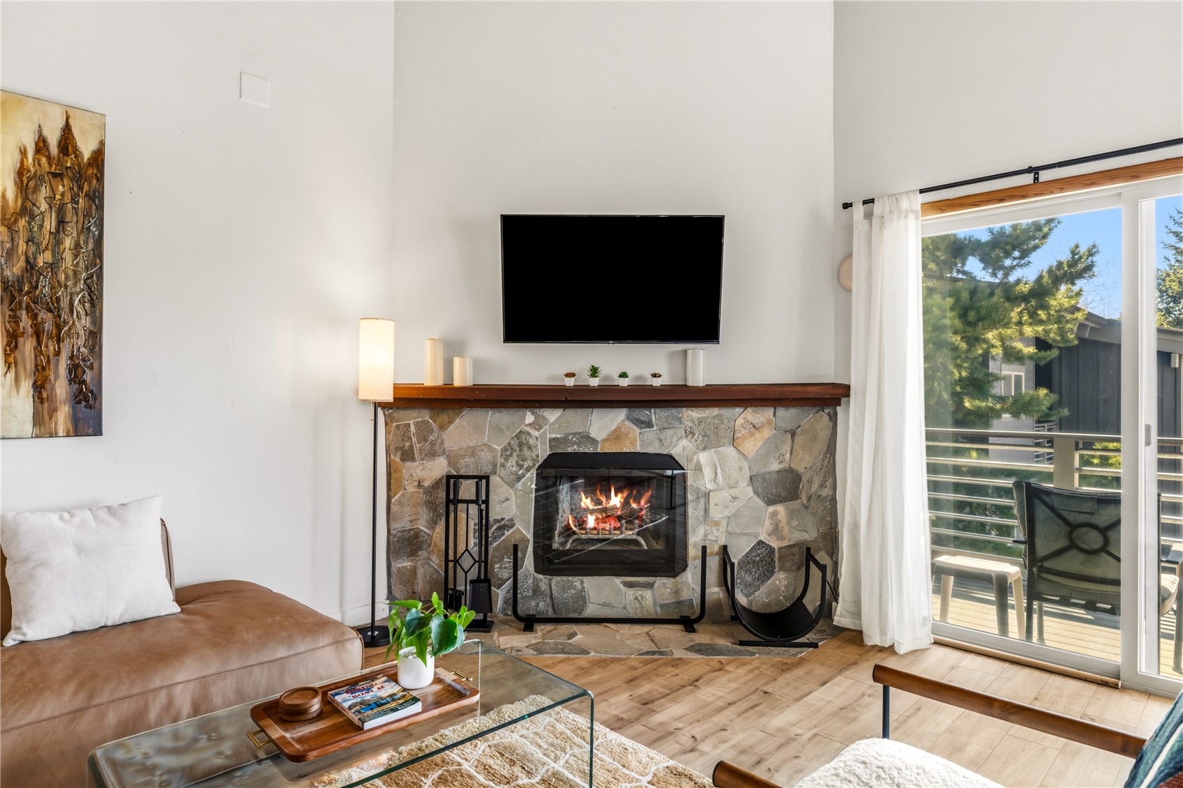 1375 Walton Creek Road, Unit 14 Steamboat Springs, CO 80487 - Photo 6 of 38 a living room with furniture a flat screen tv and a fireplace