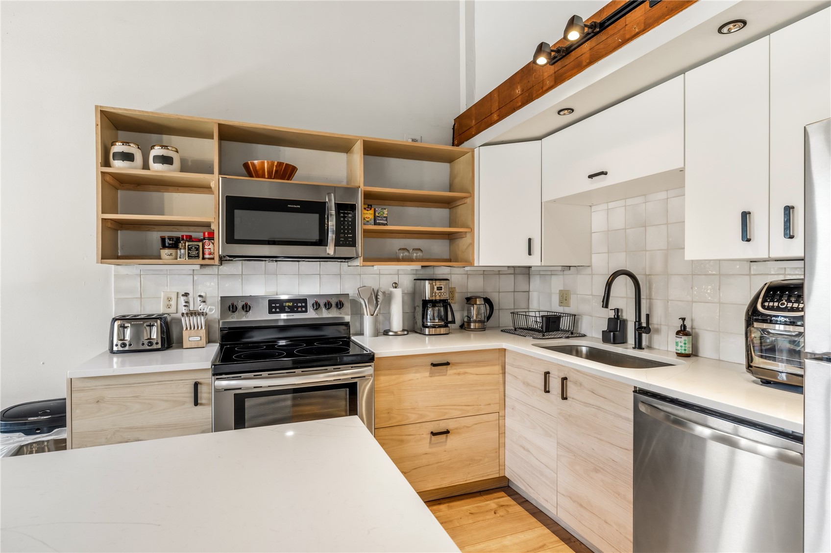 1375 Walton Creek Road, Unit 14 Steamboat Springs, CO 80487 - Photo 10 of 38 a kitchen with stainless steel appliances granite countertop a stove a sink and a microwave