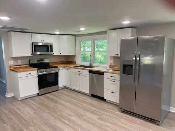 a kitchen with a white stove top oven and refrigerator
