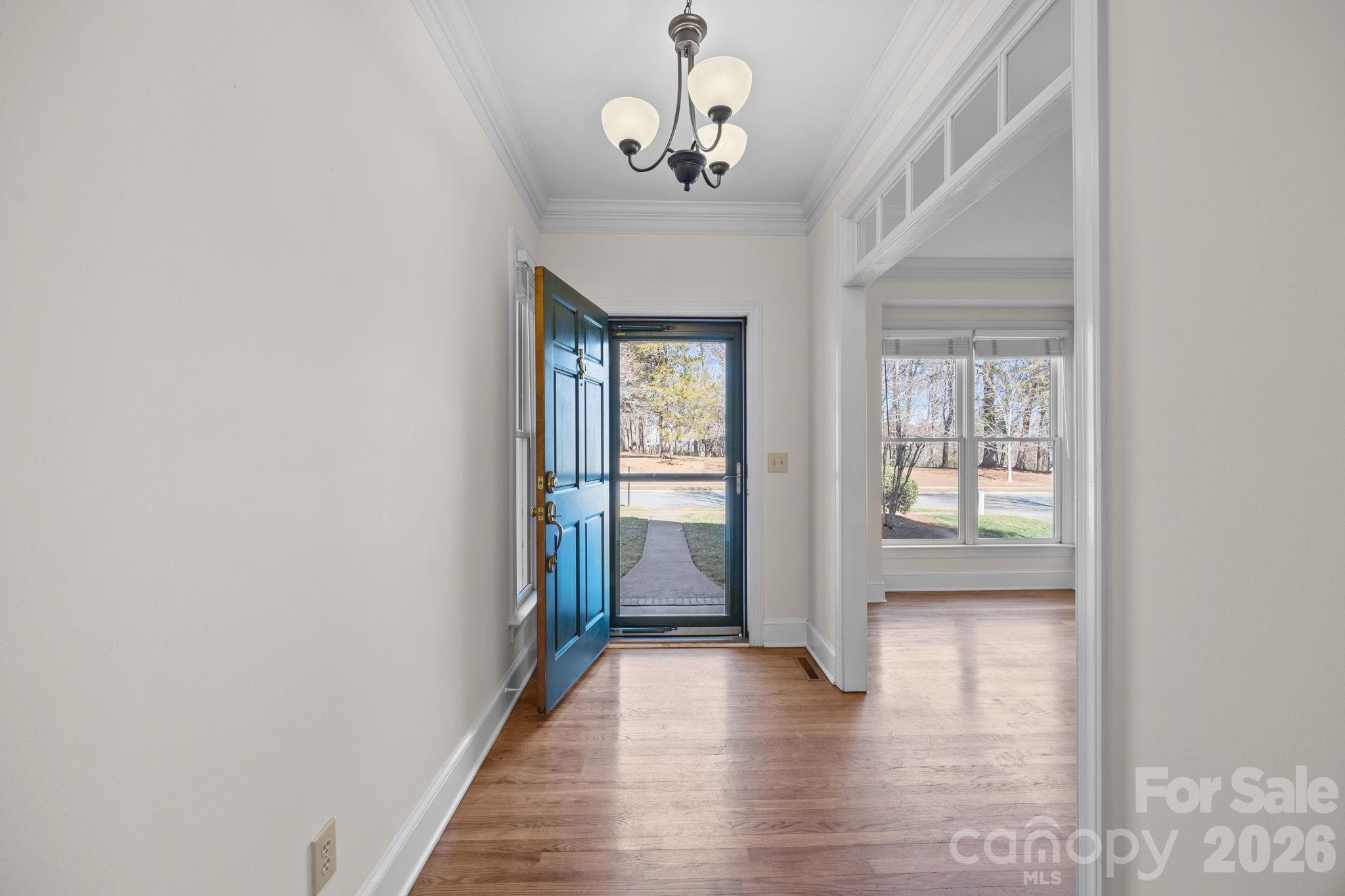 100 Martin Street Davidson, NC 28036 - Photo 14 of 47 a view of a hallway with wooden floor and a chandelier