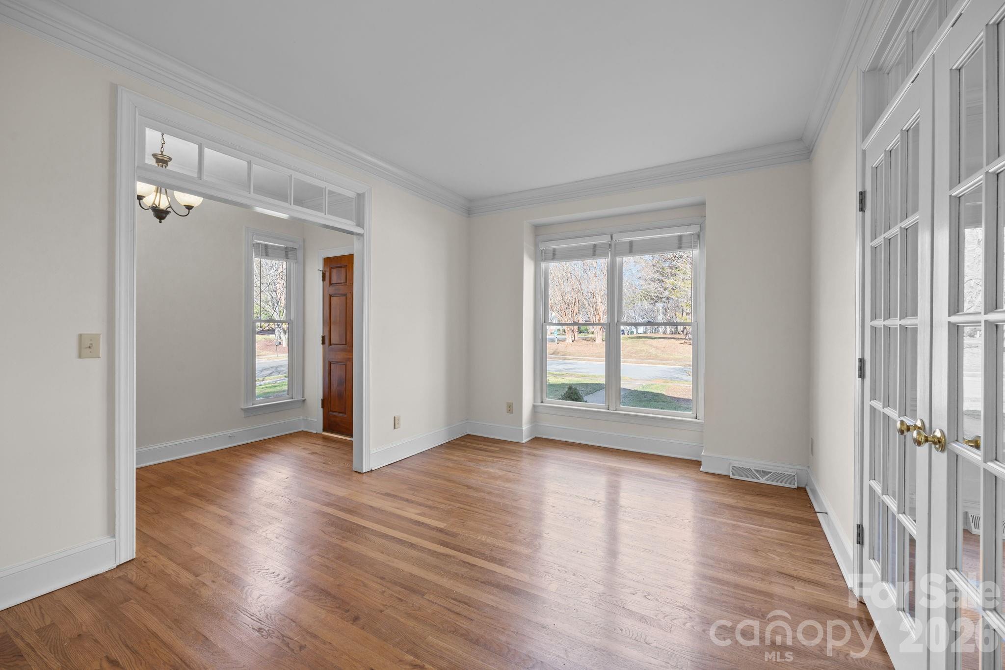 100 Martin Street Davidson, NC 28036 - Photo 18 of 47 a view of an empty room with wooden floor and a window