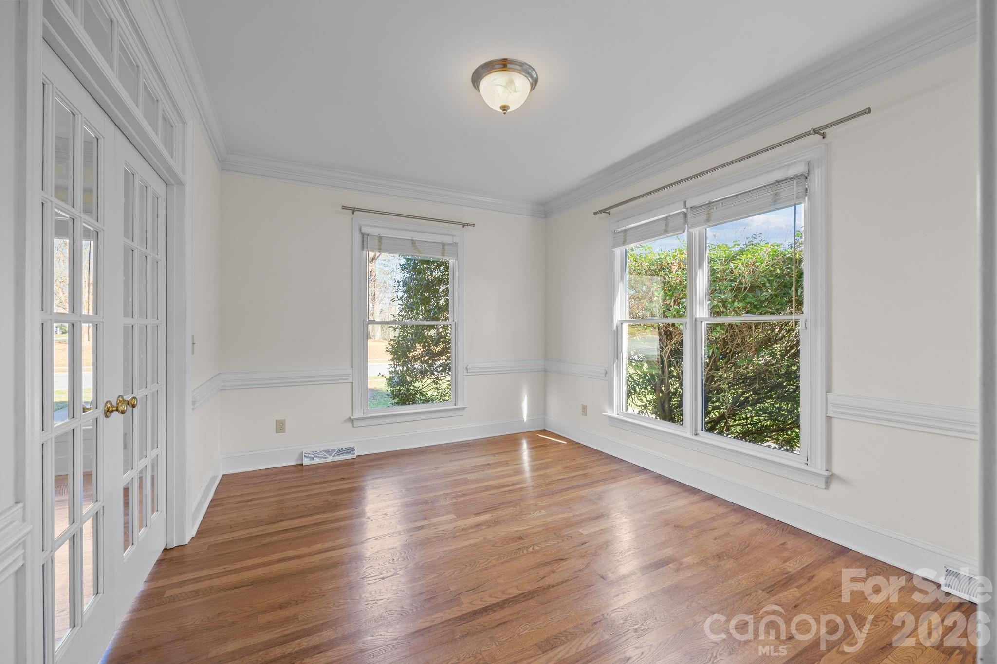 100 Martin Street Davidson, NC 28036 - Photo 19 of 47 a view of an empty room with wooden floor and a window
