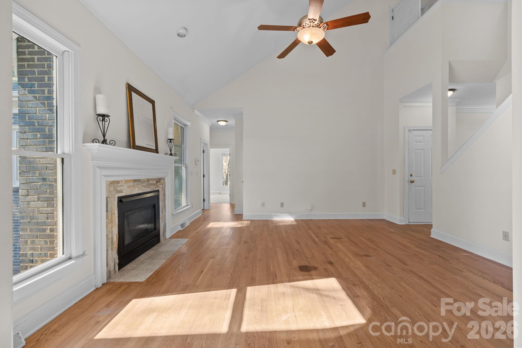 100 Martin Street Davidson, NC 28036 - Photo 20 of 47 wooden floor in an empty room with a fireplace and window