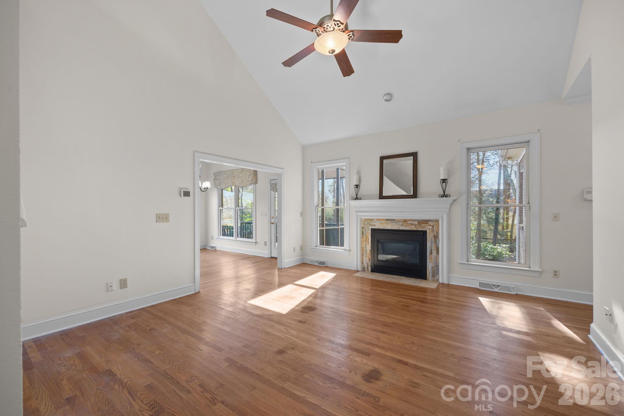 100 Martin Street Davidson, NC 28036 - Photo 22 of 47 a view of a livingroom with a fireplace a ceiling fan and windows