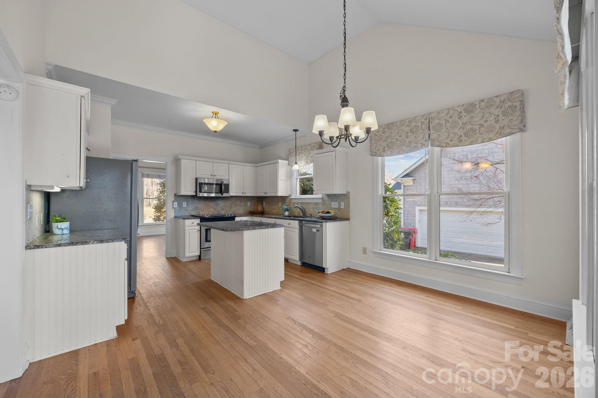 100 Martin Street Davidson, NC 28036 - Photo 23 of 47 a large kitchen with kitchen island white cabinets and stainless steel appliances