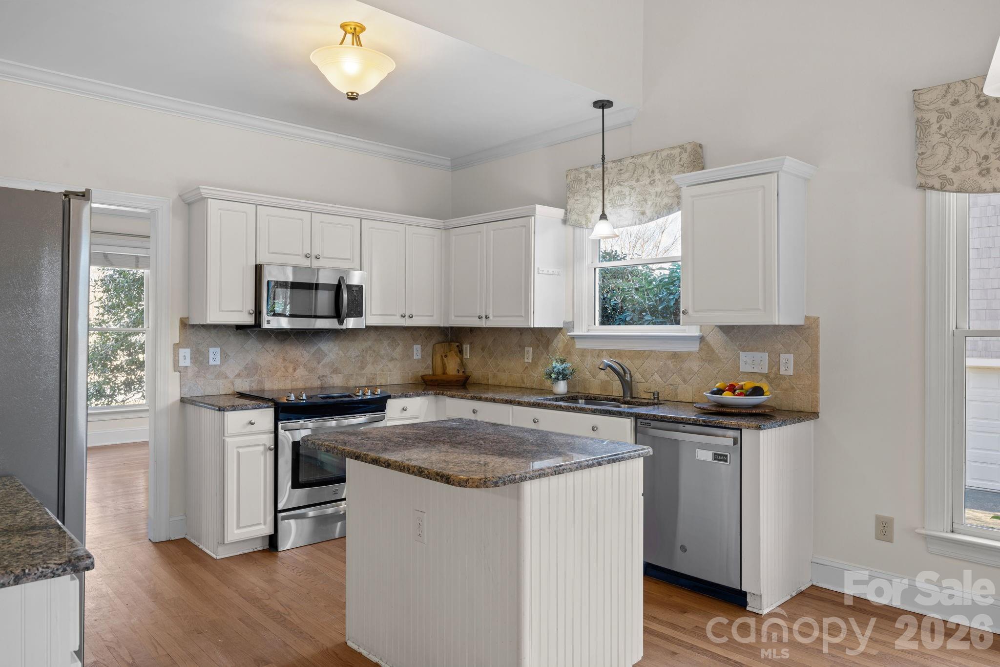 100 Martin Street Davidson, NC 28036 - Photo 27 of 47 a kitchen with stainless steel appliances granite countertop a stove a sink and a refrigerator