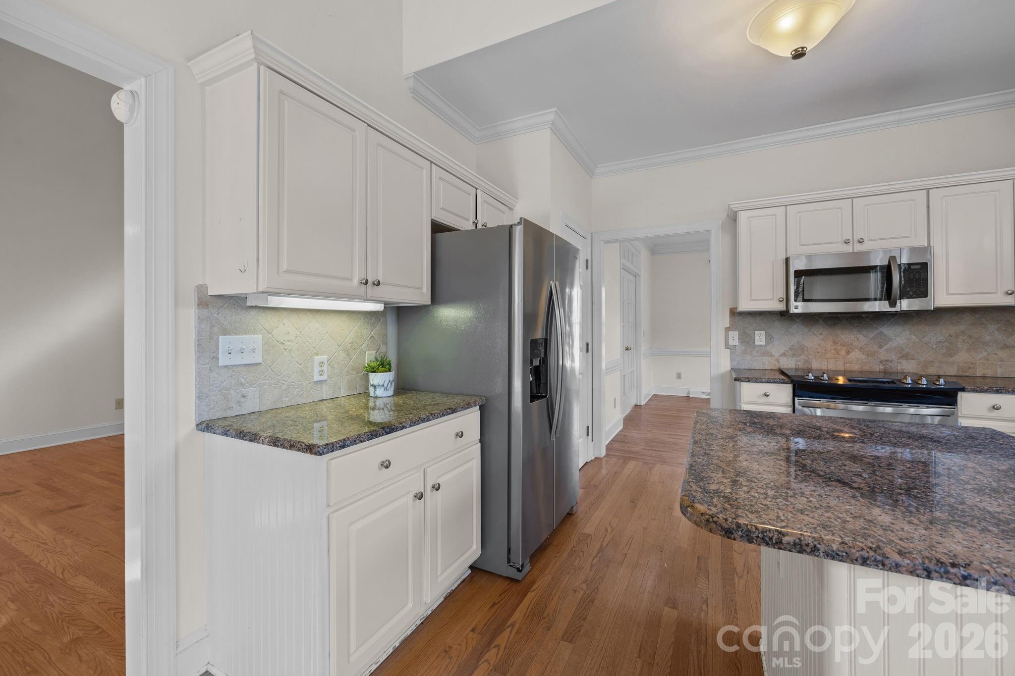 100 Martin Street Davidson, NC 28036 - Photo 31 of 47 a kitchen with stainless steel appliances granite countertop a sink stove and refrigerator