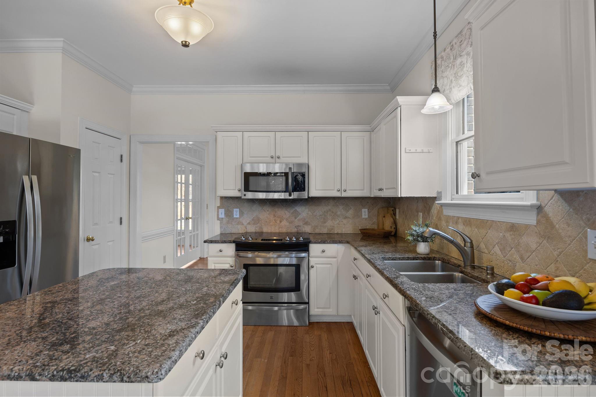 100 Martin Street Davidson, NC 28036 - Photo 32 of 47 a kitchen with stainless steel appliances granite countertop a sink stove and refrigerator