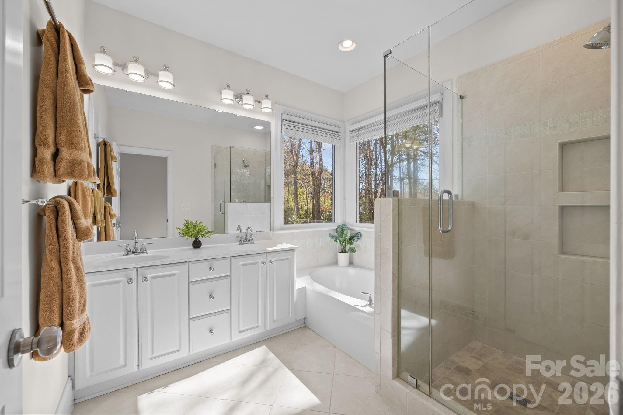 100 Martin Street Davidson, NC 28036 - Photo 38 of 47 a spacious bathroom with a shower sink and mirror