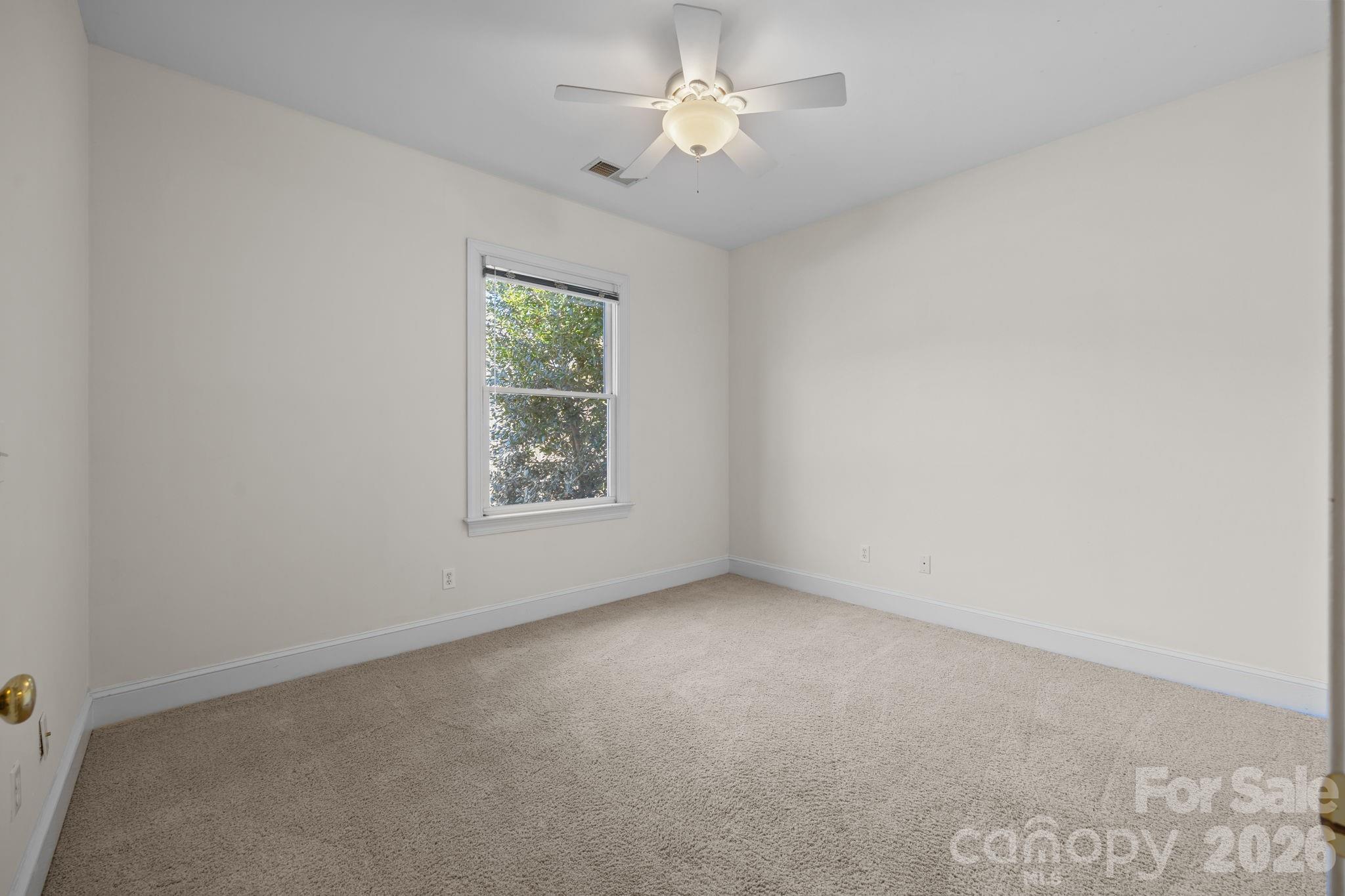 100 Martin Street Davidson, NC 28036 - Photo 43 of 47 an empty room with a window and a fan