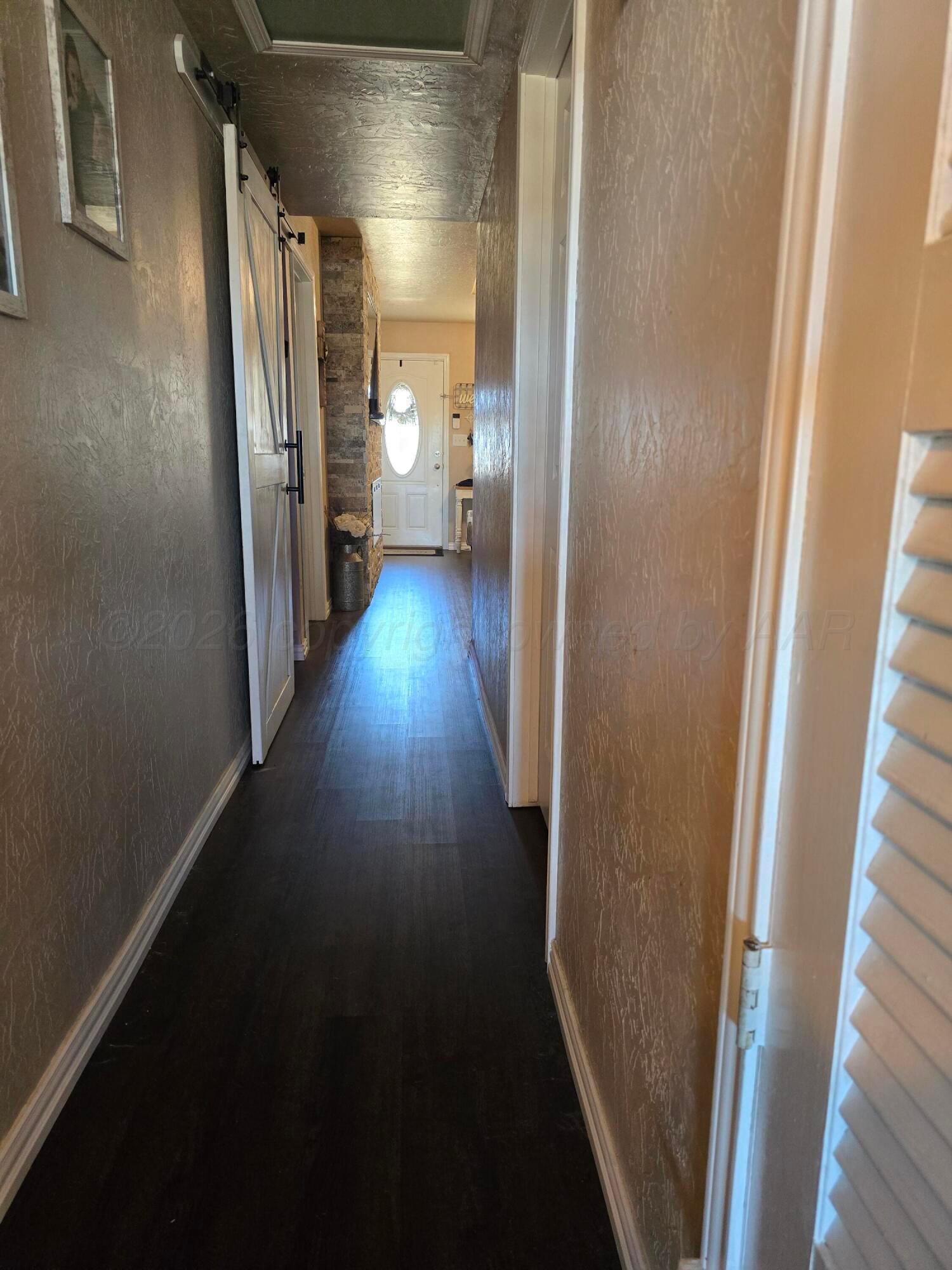 1121 Elmore Street Borger, TX 79007 - Photo 14 of 39 a view of hallway with wooden floor