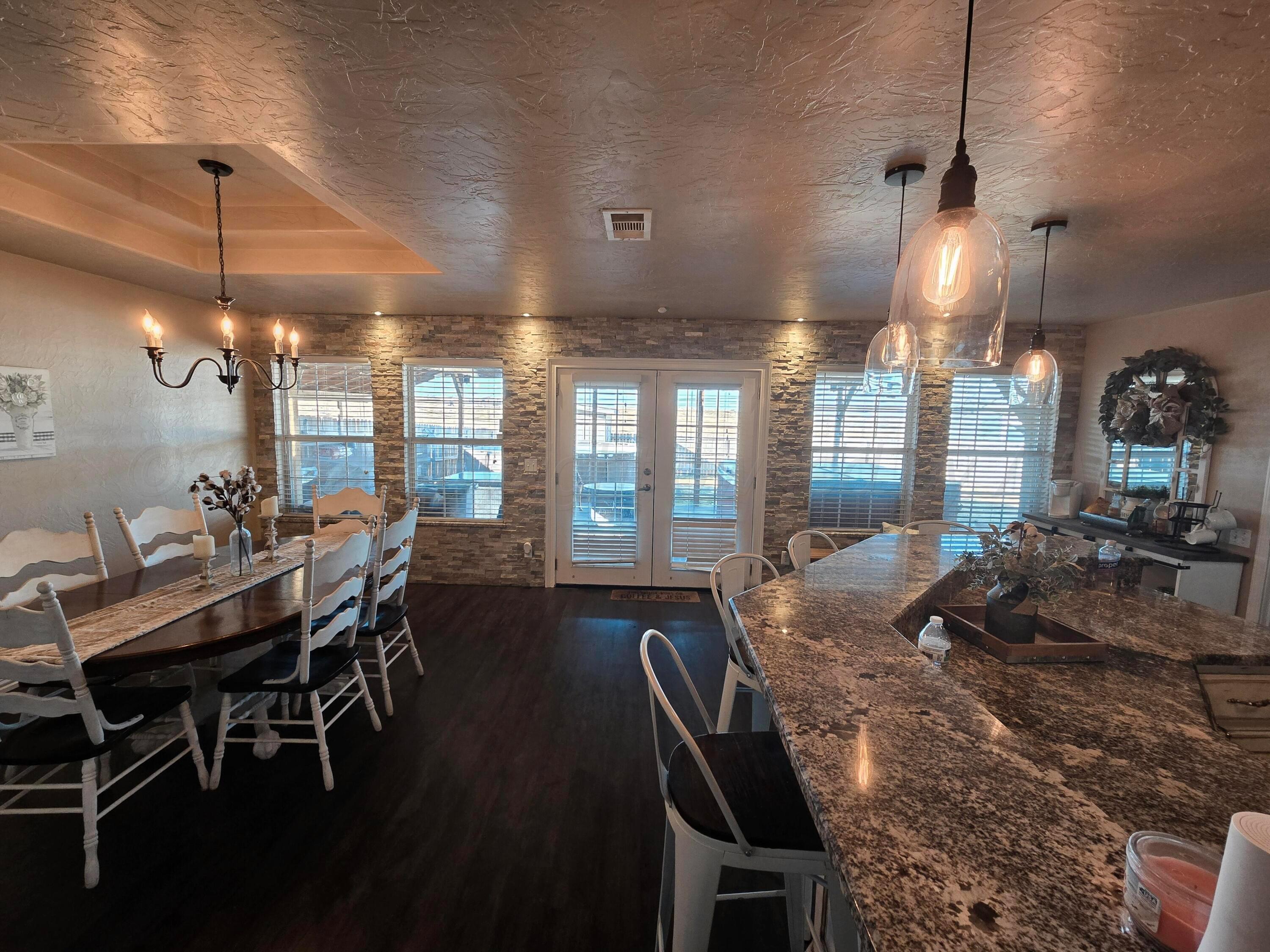 1121 Elmore Street Borger, TX 79007 - Photo 15 of 39 a view of a dining room with furniture window and wooden floor