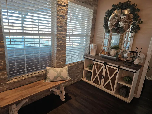 a wooden bench sitting in front of a window