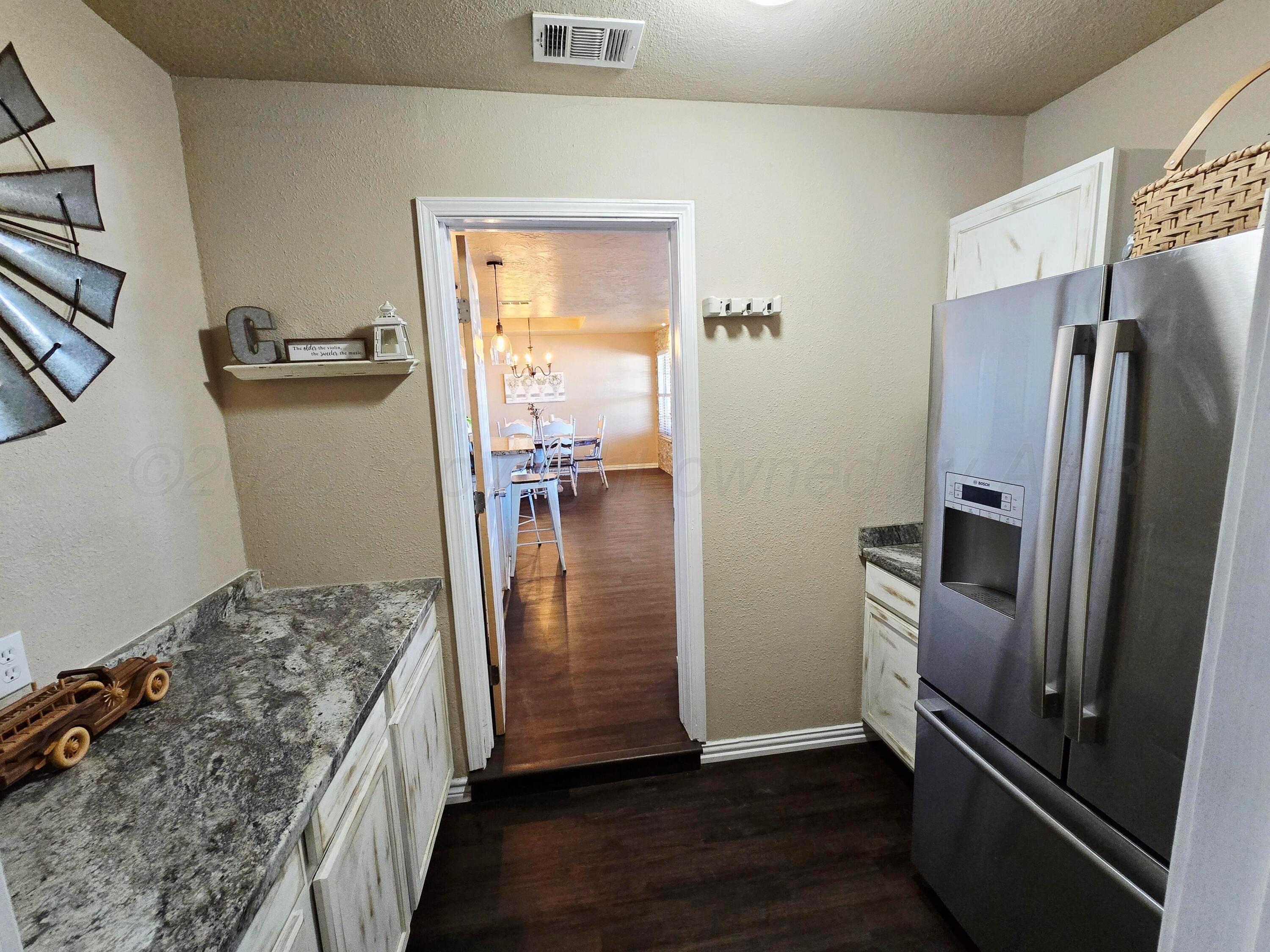 1121 Elmore Street Borger, TX 79007 - Photo 25 of 39 a kitchen with a refrigerator and a stove