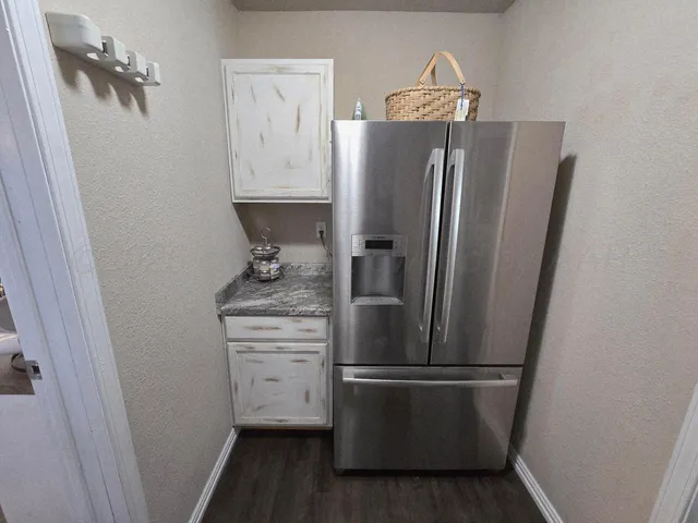 a white refrigerator freezer sitting inside of a kitchen