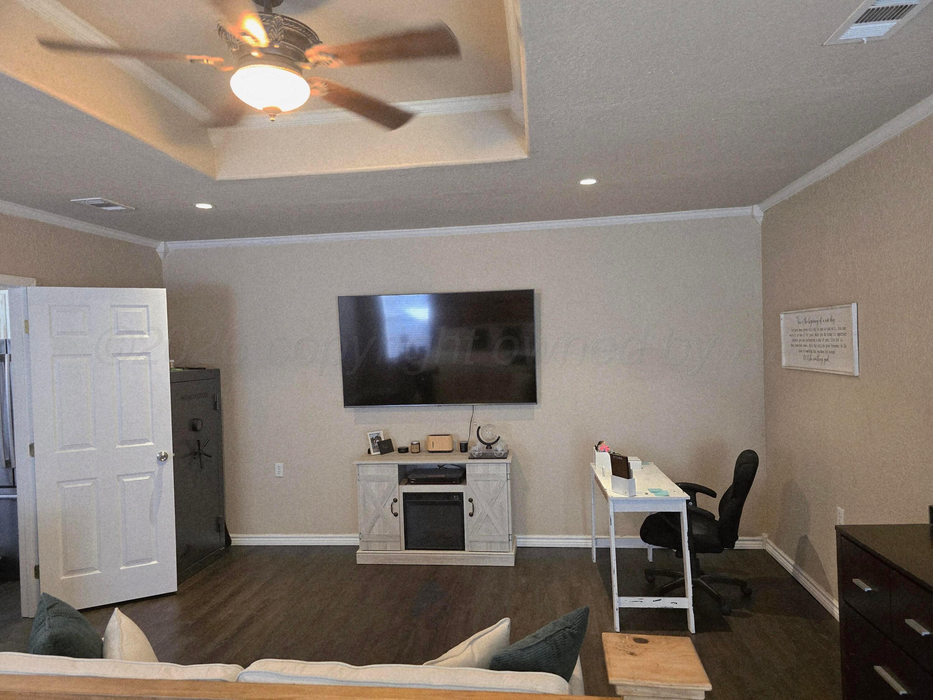1121 Elmore Street Borger, TX 79007 - Photo 29 of 39 a living room with furniture and a flat screen tv