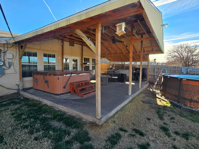 a view of a backyard with sitting area