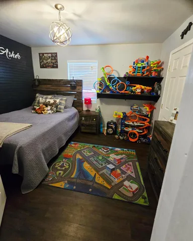 a bedroom with furniture and a window