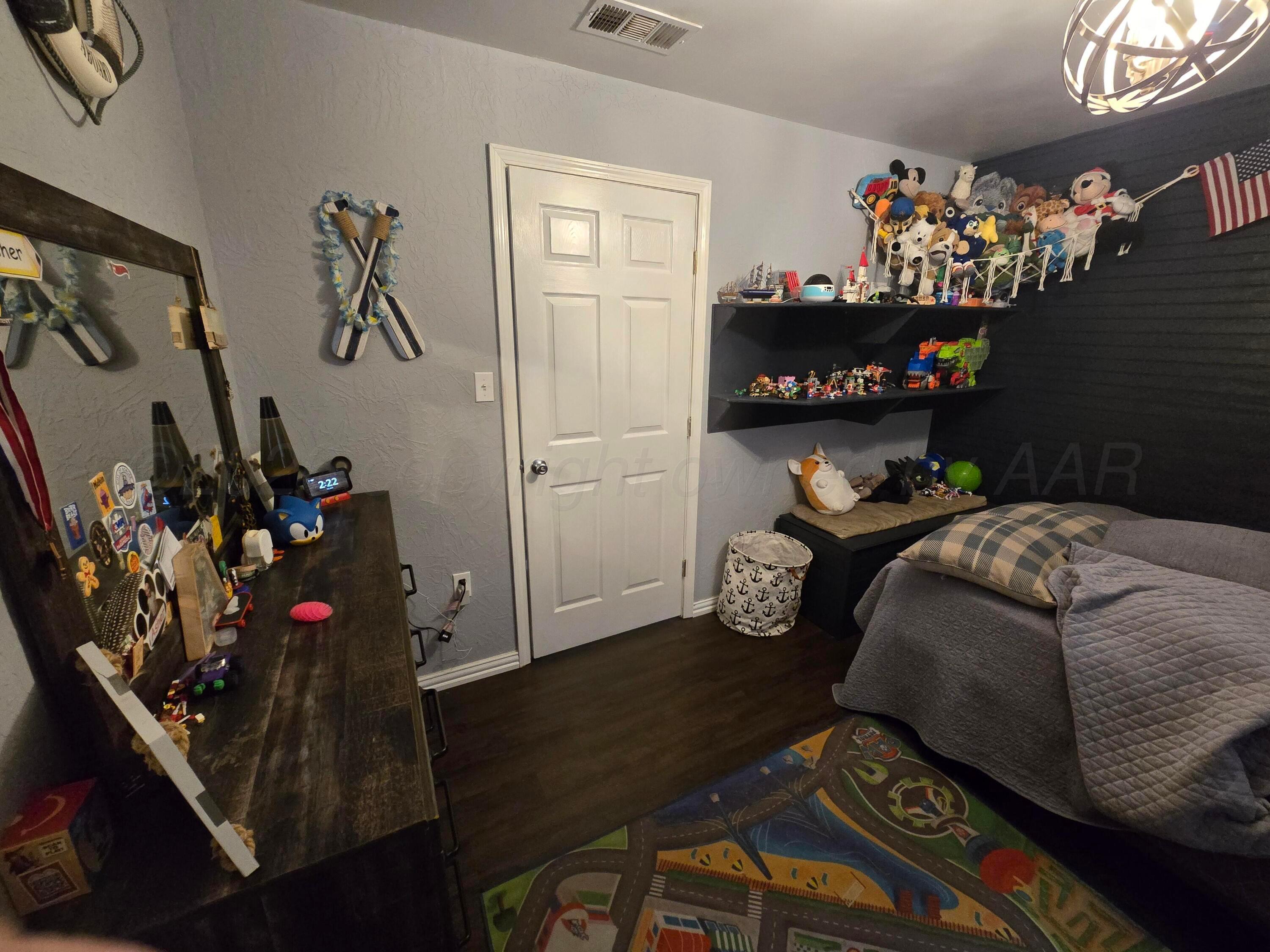 1121 Elmore Street Borger, TX 79007 - Photo 33 of 39 a bedroom with furniture and a window